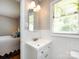 Bright bathroom with white subway tile, a vanity with a window, and view of the bedroom at 6616 Williams Rd, Charlotte, NC 28215