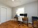 Bedroom with hardwood floors, neutral paint, a ceiling fan, and space for a home office at 6616 Williams Rd, Charlotte, NC 28215