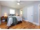 Bedroom featuring hardwood floors, white trim, with a ceiling fan and natural light at 6616 Williams Rd, Charlotte, NC 28215