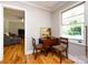 Cozy dining nook features a wooden table with hardwood floors and a large window at 6616 Williams Rd, Charlotte, NC 28215