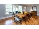 Dining room with hardwood floors, a long table, and large windows at 6616 Williams Rd, Charlotte, NC 28215