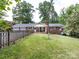 Brick home with an attached garage and a fenced yard at 6616 Williams Rd, Charlotte, NC 28215