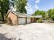 A one-story brick house with an attached two-car garage and mature landscaping at 6616 Williams Rd, Charlotte, NC 28215