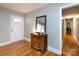 View of foyer with wooden floors and a dresser next to the front door at 6616 Williams Rd, Charlotte, NC 28215