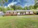 Charming brick ranch home with a well-manicured lawn and inviting front porch at 6616 Williams Rd, Charlotte, NC 28215