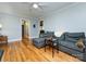 Bright living room features hardwood floors and a comfortable gray sofa at 6616 Williams Rd, Charlotte, NC 28215