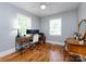 Home office featuring hardwood floors, natural light, and a spacious desk and chair at 6616 Williams Rd, Charlotte, NC 28215