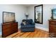 Cozy sitting room with hardwood floors, a chair, and accent furniture at 6616 Williams Rd, Charlotte, NC 28215