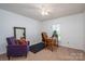 Cozy bedroom with a desk, chair, and a purple lounge seat at 695 Linwood Rd, Mooresville, NC 28115