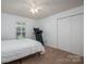Bright bedroom featuring neutral carpet, fan, and closet at 695 Linwood Rd, Mooresville, NC 28115