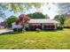 Charming single-story home with a well-manicured lawn and mature landscaping creating curb appeal at 695 Linwood Rd, Mooresville, NC 28115