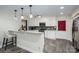 Modern kitchen with a breakfast bar, white cabinetry, stainless steel appliances, and stylish pendant lighting at 695 Linwood Rd, Mooresville, NC 28115