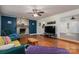 Cozy living room featuring a stone fireplace, hardwood floors, and stylish decor, perfect for Gathering gatherings at 695 Linwood Rd, Mooresville, NC 28115