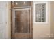 Bathroom shower featuring tile surround and glass block window at 695 Linwood Rd, Mooresville, NC 28115