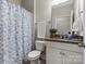 Clean bathroom with granite counter, and shower with patterned curtain at 7039 Chrysanthemum Rd, Lancaster, SC 29720