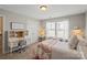 Bright bedroom features a built-in desk, chair, and a cozy bed with a decorative quilt at 7039 Chrysanthemum Rd, Lancaster, SC 29720