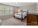 Bedroom with a four-poster bed, a neutral palette, and a large window, creating a calm and inviting space at 7039 Chrysanthemum Rd, Lancaster, SC 29720