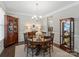 Elegant dining room featuring a round table, decorative chandelier, and dark hardwood floors at 7039 Chrysanthemum Rd, Lancaster, SC 29720