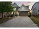 Charming two-story home with stone accents, a two-car garage, and a well-manicured front yard at 7039 Chrysanthemum Rd, Lancaster, SC 29720