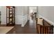 Elegant hallway with dark hardwood floors, white wainscoting, and a decorative display cabinet at 7039 Chrysanthemum Rd, Lancaster, SC 29720
