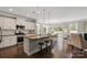Open kitchen features an island with granite counters, pendant lights, and stainless appliances at 7039 Chrysanthemum Rd, Lancaster, SC 29720