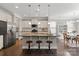 Bright eat-in kitchen features an island with seating, pendant lights, and stainless appliances at 7039 Chrysanthemum Rd, Lancaster, SC 29720