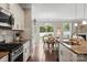 Bright kitchen featuring an island, stainless steel appliances, and seamless flow into the dining area at 7039 Chrysanthemum Rd, Lancaster, SC 29720