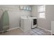 Laundry room featuring a washer, dryer, ironing board and overhead shelving at 7039 Chrysanthemum Rd, Lancaster, SC 29720