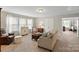 Comfortable living room featuring neutral colors, ample seating, and natural light from the large windows at 7039 Chrysanthemum Rd, Lancaster, SC 29720