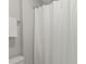 Neutral-toned bathroom featuring a white shower curtain, accented by matching towel at 7039 Chrysanthemum Rd, Lancaster, SC 29720