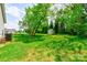 Spacious backyard with a storage shed and bordered by mature trees at 704 E Catawba St, Belmont, NC 28012