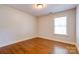 Bedroom featuring hardwood floors and a window at 704 E Catawba St, Belmont, NC 28012