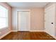 Bedroom featuring hardwood floors, a closet, and a window at 704 E Catawba St, Belmont, NC 28012