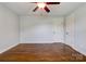 Bedroom featuring hardwood floors, a ceiling fan, and closet door at 704 E Catawba St, Belmont, NC 28012