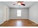 Bright bedroom featuring hardwood floors and a ceiling fan at 704 E Catawba St, Belmont, NC 28012