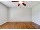 Spacious bedroom featuring hardwood floors and a ceiling fan at 704 E Catawba St, Belmont, NC 28012