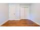 Bedroom featuring hardwood floors and closet doors at 704 E Catawba St, Belmont, NC 28012