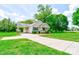 View of the home's exterior, featuring an attached carport and landscaped front yard at 704 E Catawba St, Belmont, NC 28012