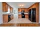 Kitchen featuring wood cabinets, modern appliances, and access to laundry room at 704 E Catawba St, Belmont, NC 28012