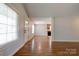 Bright living room featuring hardwood floors and a view into the kitchen at 704 E Catawba St, Belmont, NC 28012