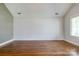 Spacious living room featuring hardwood floors, large windows, and neutral paint at 704 E Catawba St, Belmont, NC 28012