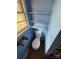 Compact blue bathroom featuring a toilet and a window for natural light, complemented by convenient storage shelves at 785 Nc Highway 109 N Hwy, Troy, NC 27371