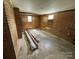 A bedroom featuring brick and wood paneled walls, as well as rolled up carpets at 785 Nc Highway 109 N Hwy, Troy, NC 27371