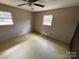 Simple bedroom with neutral walls and a linoleum floor, featuring two windows for natural lighting at 785 Nc Highway 109 N Hwy, Troy, NC 27371