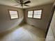 Bedroom with two windows offering natural light and a ceiling fan for added comfort at 785 Nc Highway 109 N Hwy, Troy, NC 27371