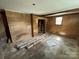 A bedroom featuring brick and wood paneled walls, as well as rolled up carpets and a closet at 785 Nc Highway 109 N Hwy, Troy, NC 27371