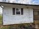 Close up shot of a white sided home with a dark shutter and white trim at 785 Nc Highway 109 N Hwy, Troy, NC 27371