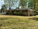 Ranch home showcasing a brick facade, mature landscaping, and a front porch at 785 Nc Highway 109 N Hwy, Troy, NC 27371
