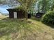 View of the back of the property with two brown outbuildings at 785 Nc Highway 109 N Hwy, Troy, NC 27371