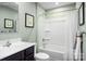 Bright bathroom with a shower-tub combo, white vanity and pale green walls at 00123 Millstream Dr, China Grove, NC 28023